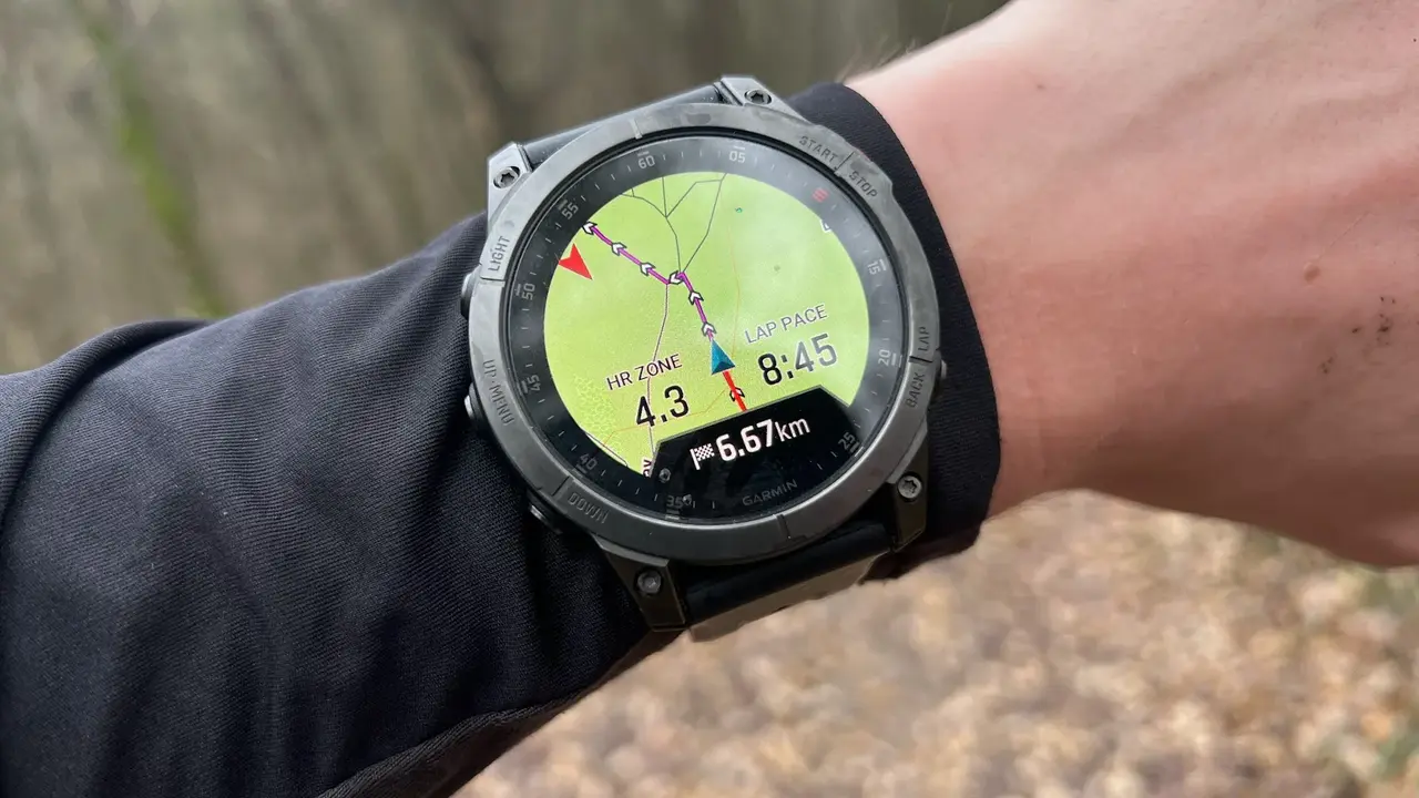 blue bowl of black bean beef tortilla soup on a board with cilantro and shredded cheese in background