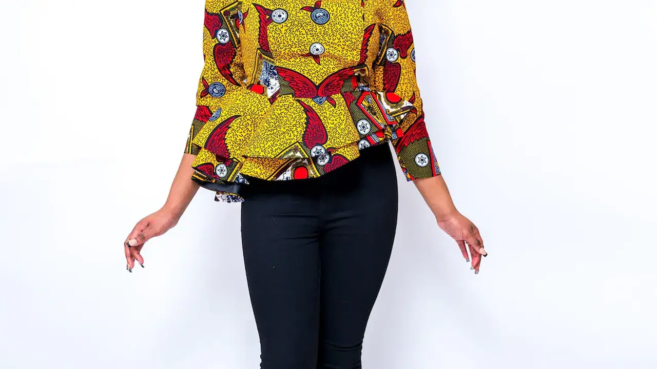 blue bowl of black bean beef tortilla soup on a board with cilantro and shredded cheese in background